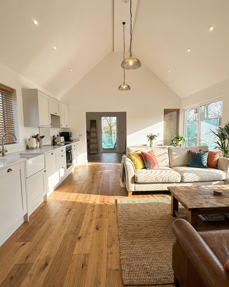 Bright Microhomes kitchen and living room with vaulted ceiling